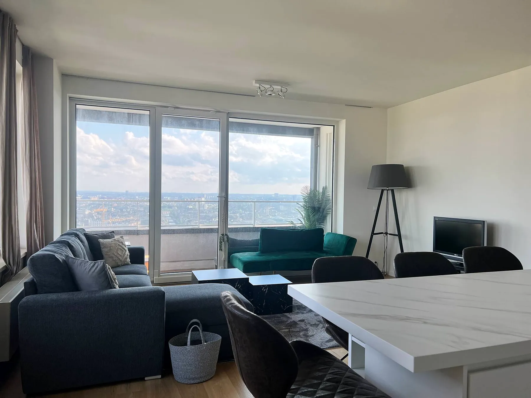 Living room with floor-to-ceiling windows and city view