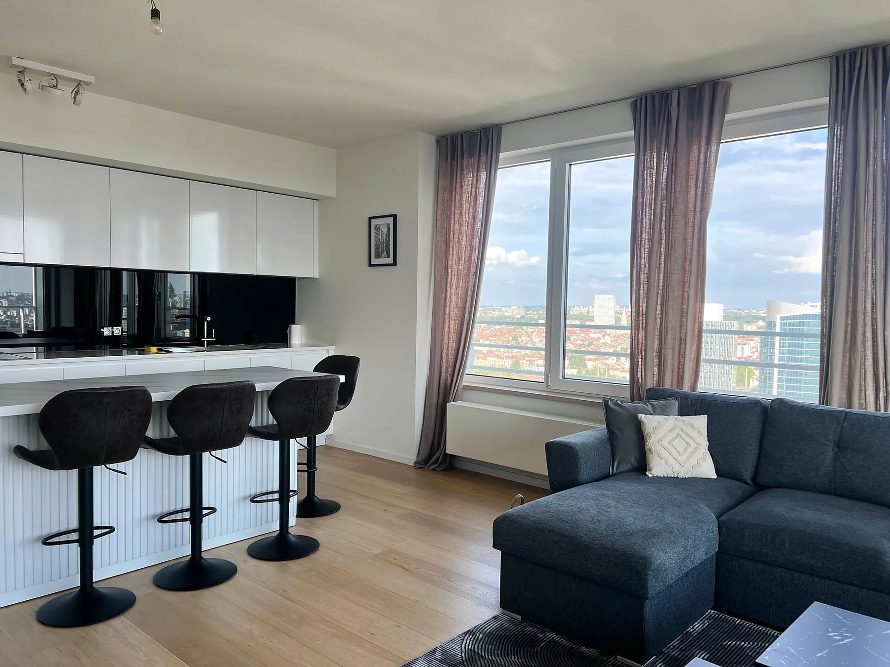 Living room with kitchen bar and corner sofa