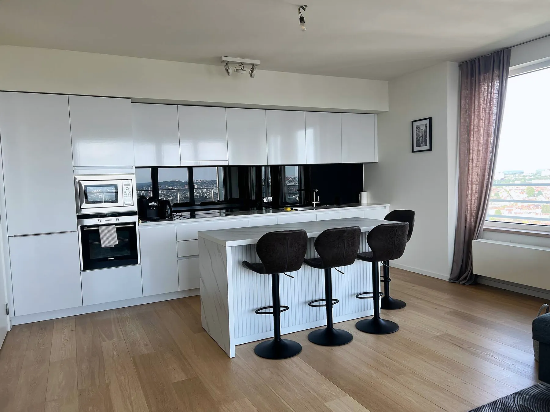 Modern white kitchen with island and bar stools