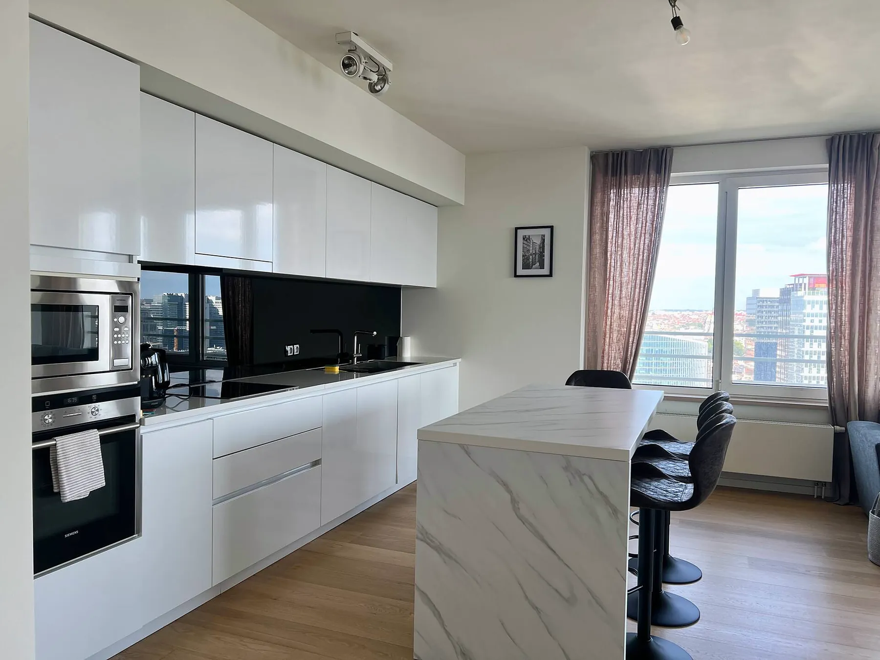 Kitchen with built-in appliances and city view