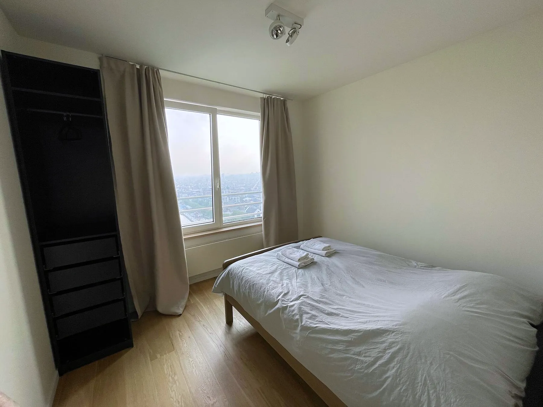 Bedroom with built-in wardrobe and city view