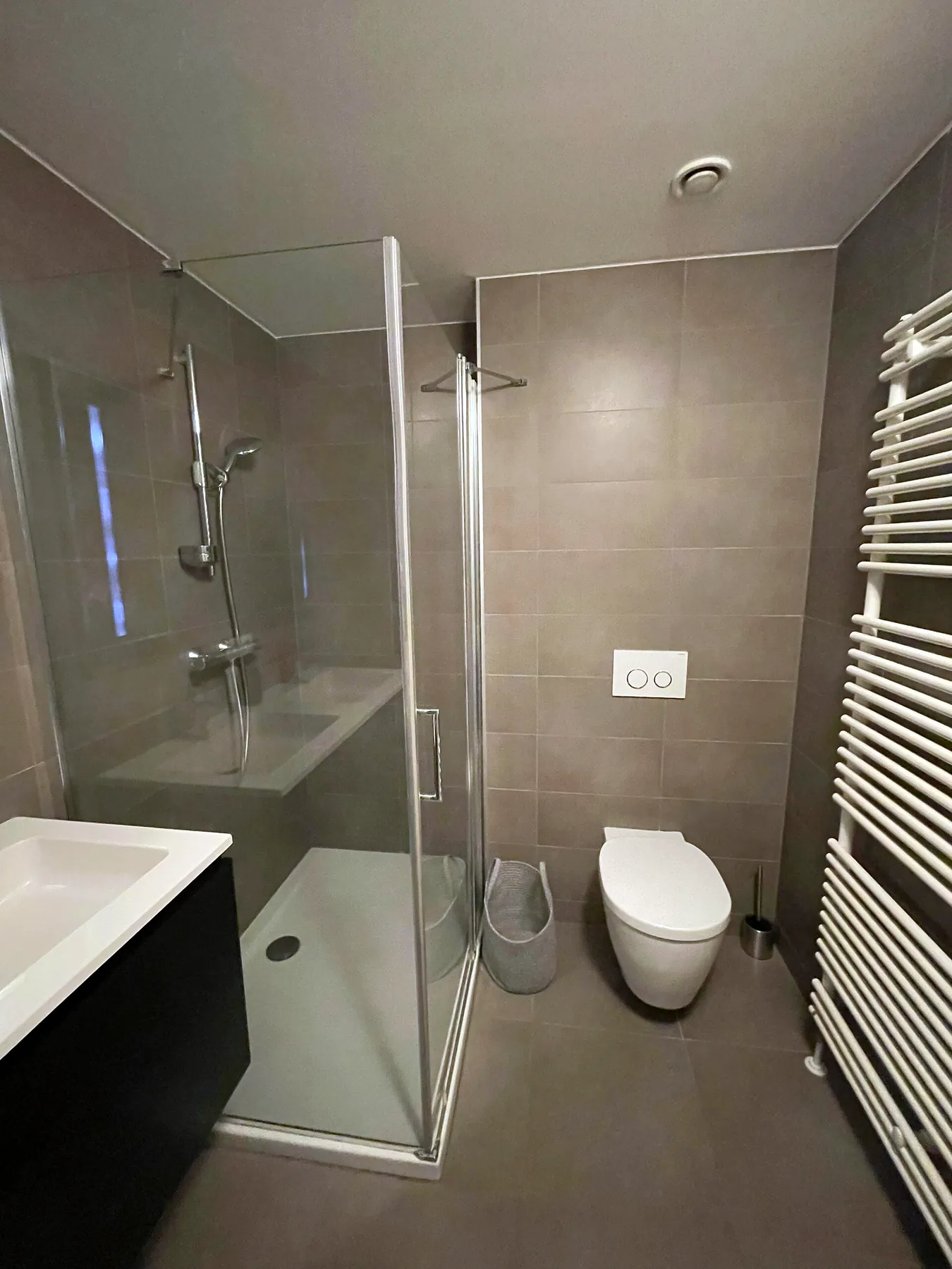 Bathroom with shower and heated towel rail