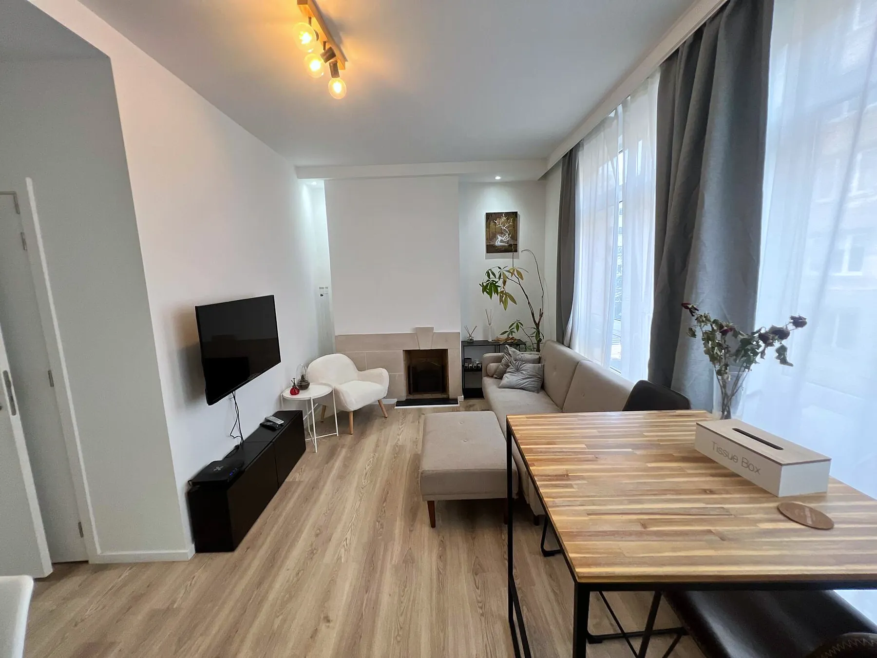 Bright living and dining room with tall windows