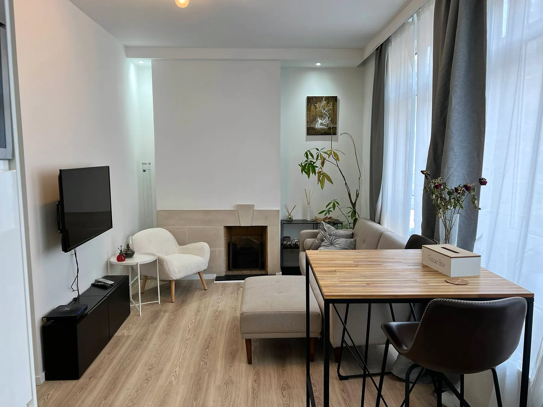 Living room with sofa, armchair and fireplace