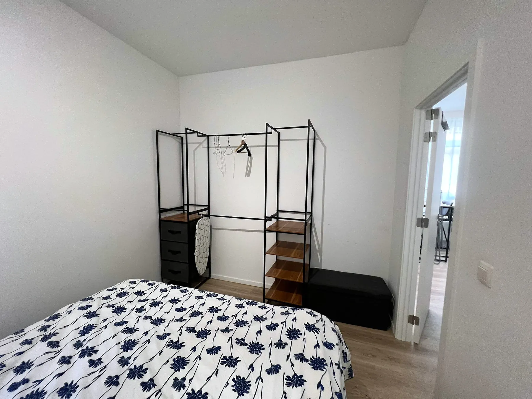 Bedroom with queen bed and open wardrobe