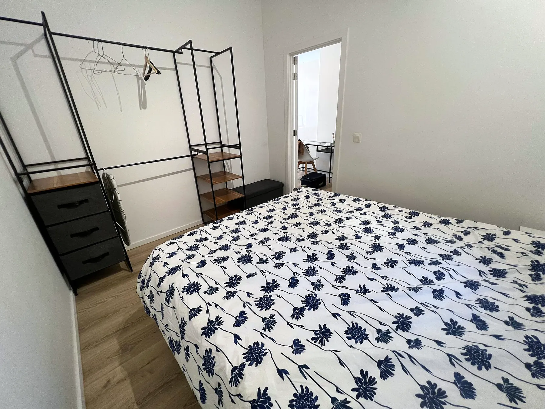 Bedroom with clothes rail and dresser