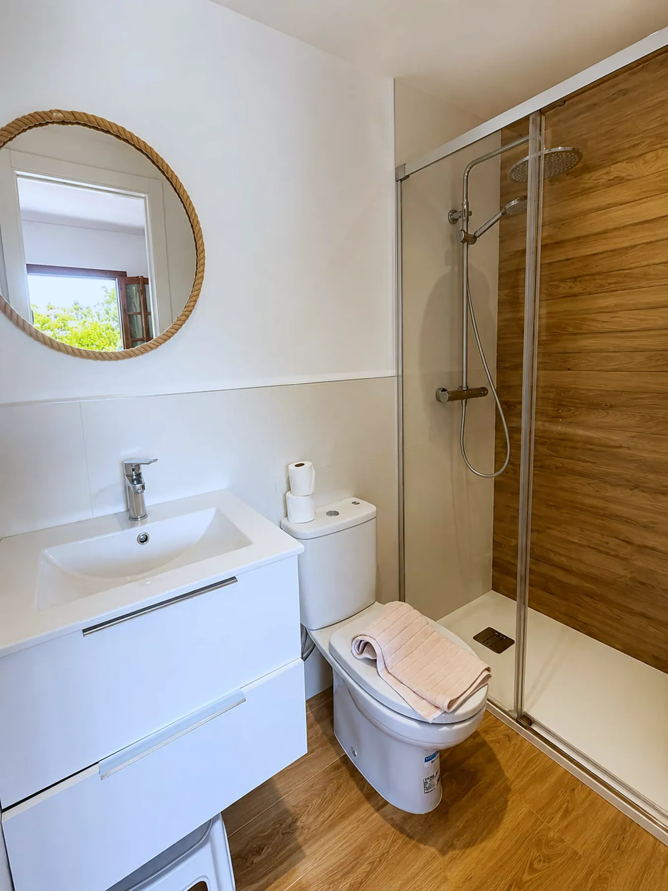 Bathroom with walk-in shower and round mirror